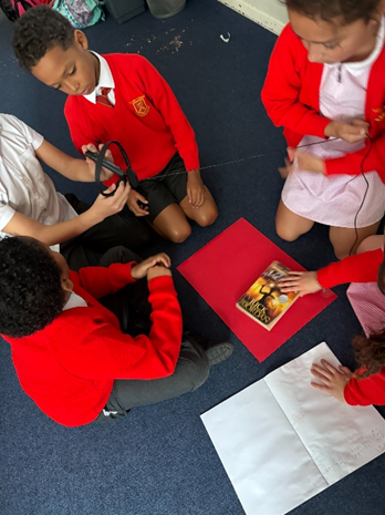 Children gathered around different objects arranging them to create interesting compositions.
