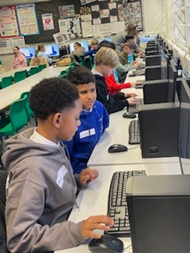 Year 6 children enjoying their computing.