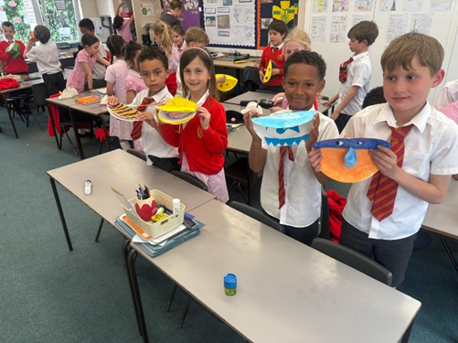 Children holding up their pneumatic toys. Some are open and some are closed.