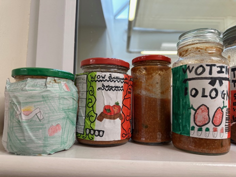 Bolognese jars with the sauce inside and labels on.