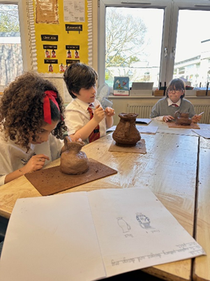 Year 5 making Greek Pots using clay.