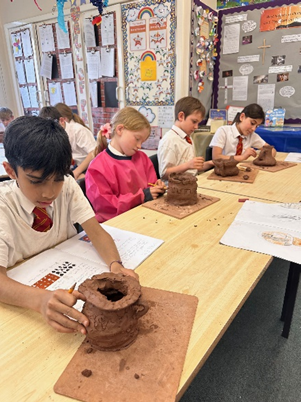 Year 5 making Greek Pots using clay.