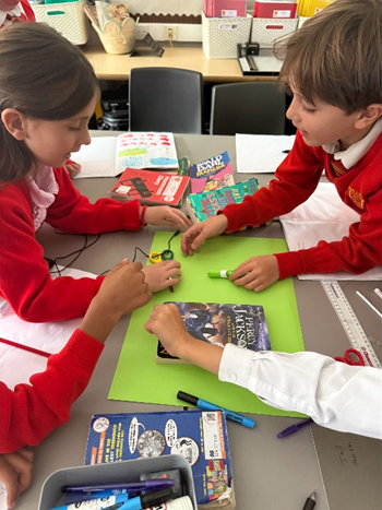 Children gathered around different objects negotiating where to place them. 