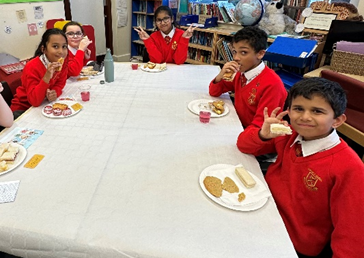 Children enjoying their cakes and biscuits