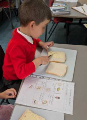Year 1 children making jam sandwiches