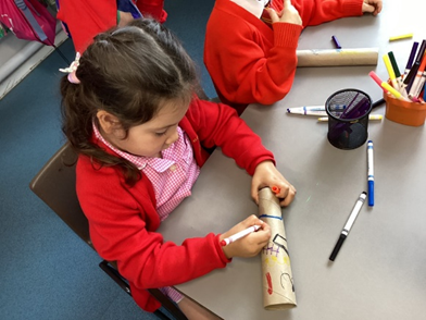 Reception child making a telescope.