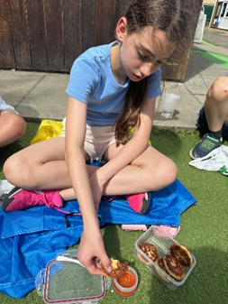 A child eating her cultural food