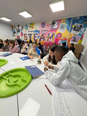 Year 6 in the STEAM room carrying out an experiment