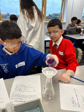 Year 6 children doing science experiments.