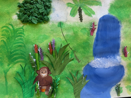 A monkey resting amongst the leaves by a waterfall
