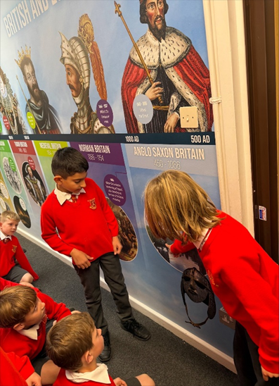 Children gathered around the World and British History Timeline looking for clues.