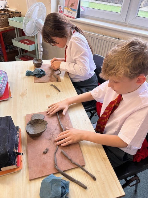Year 5 making Greek pots using clay.