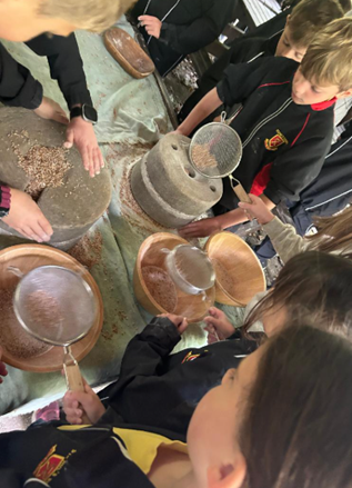 The children had great fun using ancient grinding stones to crush wheat by hand and turn it into flour