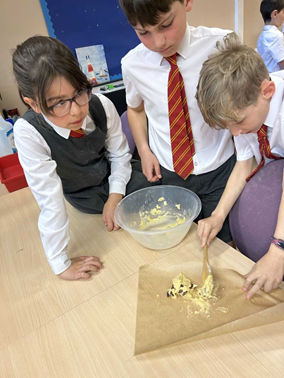 Children putting biscuit dough on baking paper