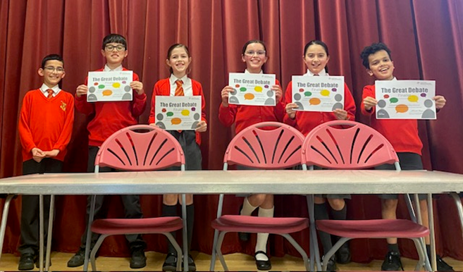 Year 5 and 6 proudly show their certificates.