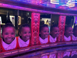 A girl smiling in to a mirror