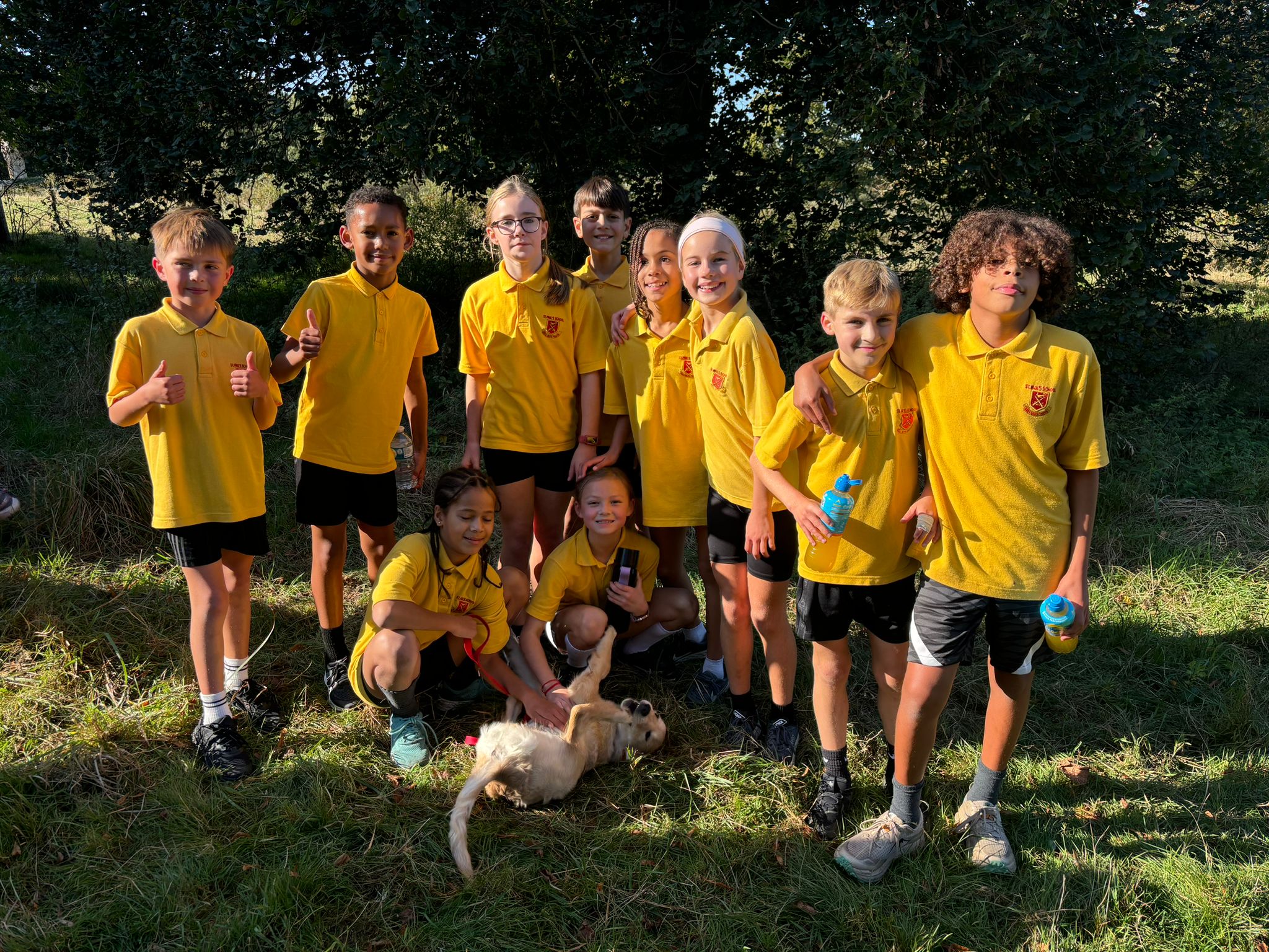 Boys and girls cross country teams with Nellie the Dog
