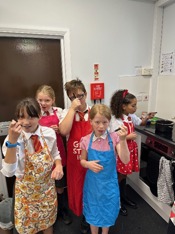 Children tasting their Bolognese sauce. 