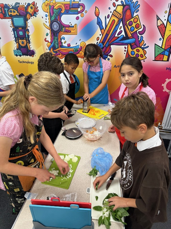 Children chopping their vegetables. 